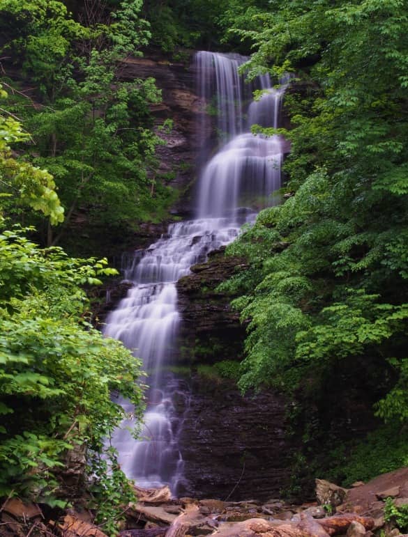 Cathedral Falls in mid-summer with great water flow surrounded by verdant flora. 