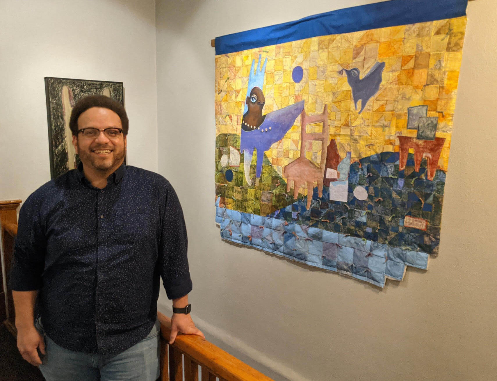 Robby with his art at Lafayette Flats Boutique Vacation Rentals.