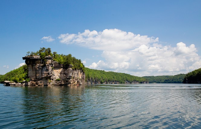 A beautiful rock cliff surrounded by the crystal blue waters of Summerville Lake. 