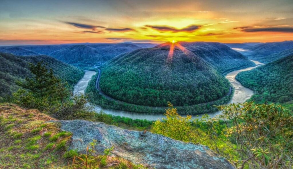 Sunset view of the horseshoe bend in the New River from the main overlook in the Grandview section of the New River Gorge National Park and Preserve. 